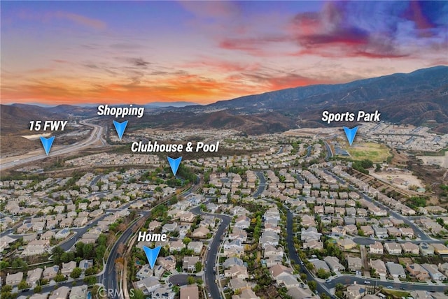 aerial view at dusk with a mountain view and a residential view