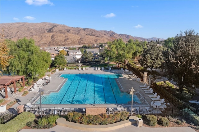 pool with a mountain view and a patio area