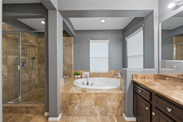 full bath featuring vanity, a bath, and a shower stall