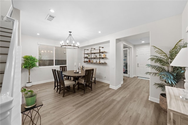 dining space with visible vents, baseboards, light wood-style flooring, and stairway