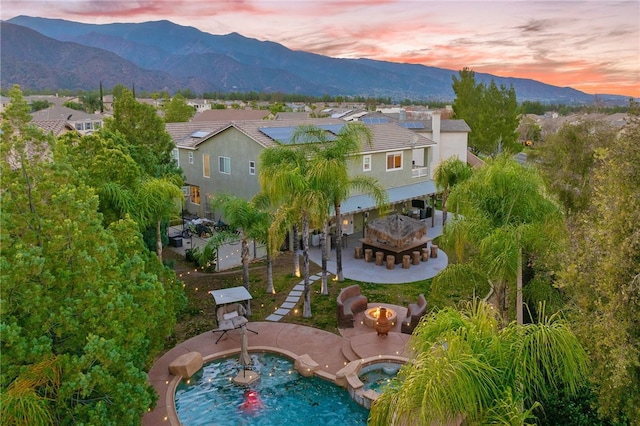 birds eye view of property featuring a mountain view