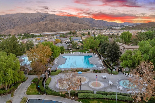 aerial view at dusk with a mountain view and a residential view