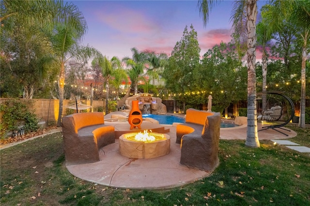 view of patio / terrace with a fenced in pool, an outdoor fire pit, and a fenced backyard