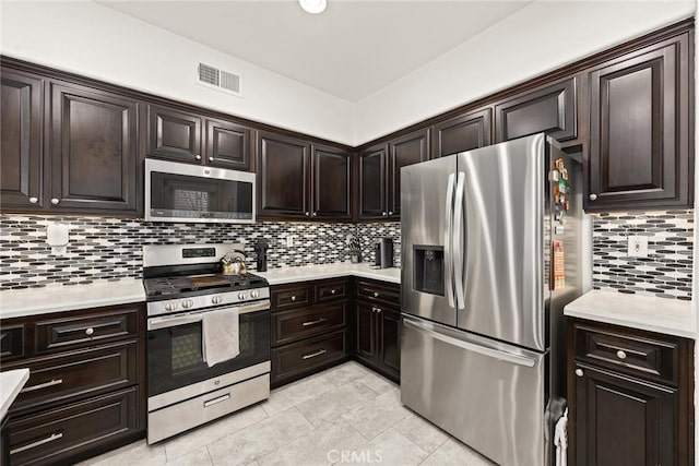 kitchen with visible vents, light countertops, dark brown cabinetry, appliances with stainless steel finishes, and tasteful backsplash