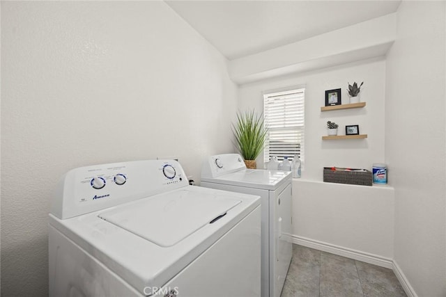 laundry area featuring laundry area, baseboards, and washer and clothes dryer