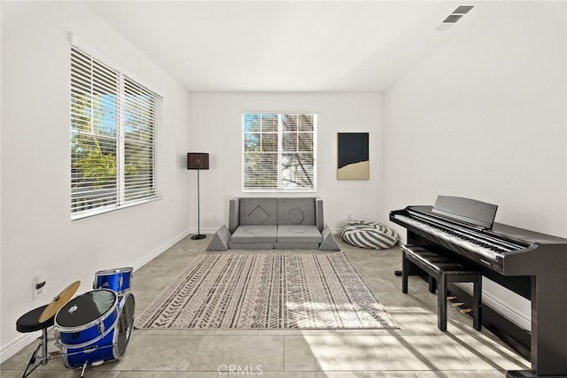 living area with visible vents and baseboards