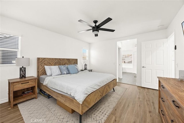 bedroom featuring light wood-style flooring, baseboards, and ceiling fan