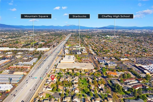 birds eye view of property with a mountain view