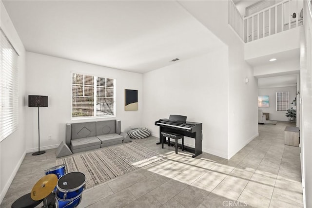 interior space with tile patterned flooring, visible vents, and baseboards