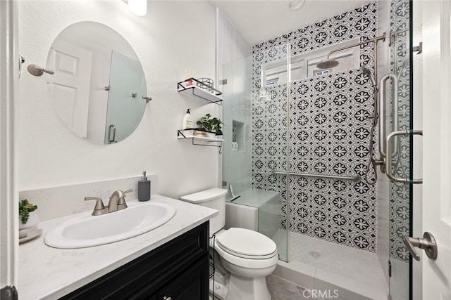 full bath with vanity, toilet, and a stall shower