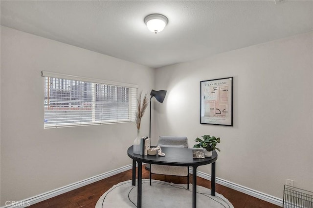 home office with visible vents, wood finished floors, and baseboards