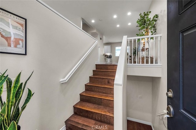 stairs with recessed lighting, baseboards, and wood finished floors