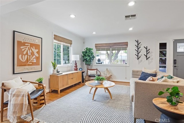 living area with visible vents, recessed lighting, and light wood-type flooring