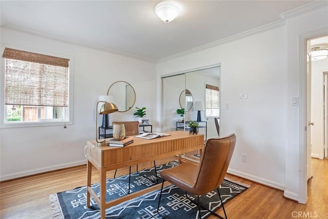 office with a healthy amount of sunlight, crown molding, baseboards, and wood finished floors