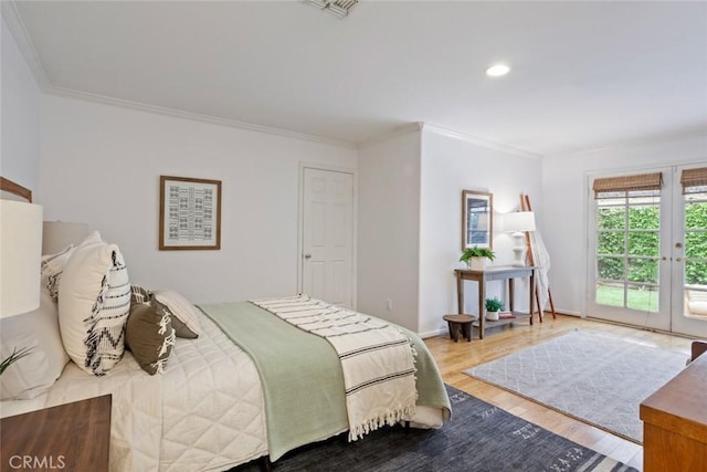 bedroom with crown molding, access to outside, wood finished floors, and french doors