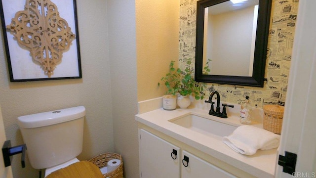 half bathroom with toilet and vanity