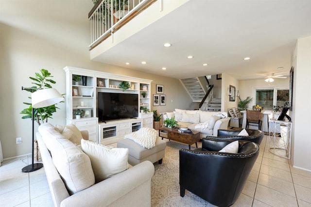 living room with baseboards, ceiling fan, stairway, light tile patterned floors, and recessed lighting