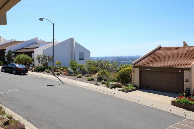 exterior space featuring curbs, street lights, and sidewalks