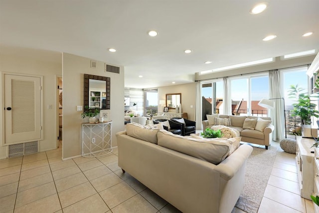 living room featuring light tile patterned floors, recessed lighting, and visible vents