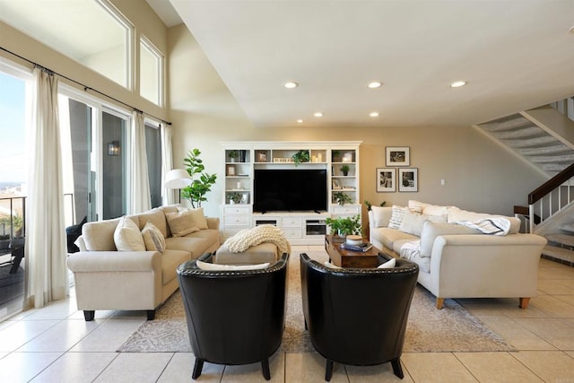 living room with stairway, light tile patterned flooring, and recessed lighting