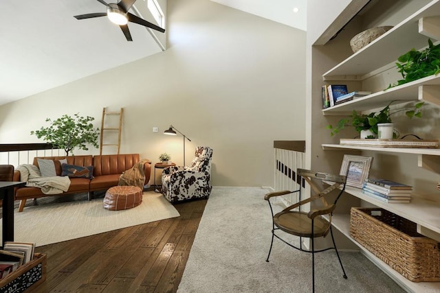 living room featuring a towering ceiling, ceiling fan, and dark wood-style flooring