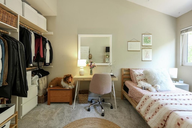 office area with carpet flooring and vaulted ceiling