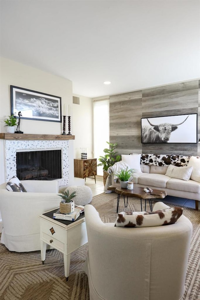 living room featuring visible vents and a high end fireplace