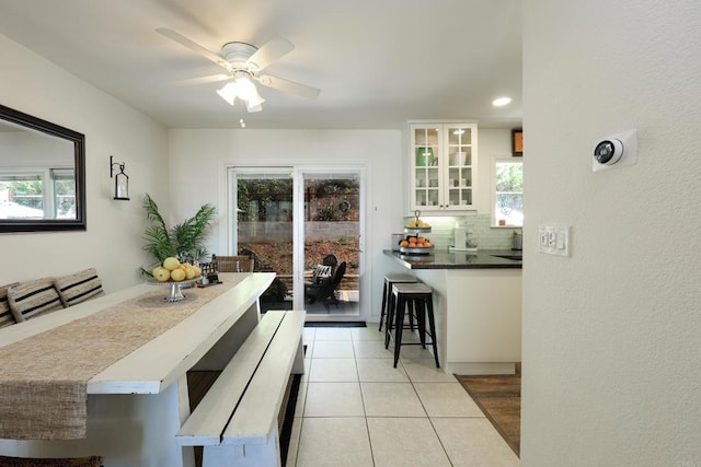 dining room with light tile patterned floors and ceiling fan