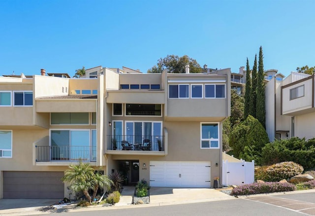 view of property with concrete driveway and an attached garage