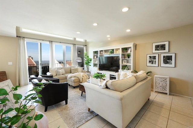 living room with light tile patterned floors, recessed lighting, and baseboards