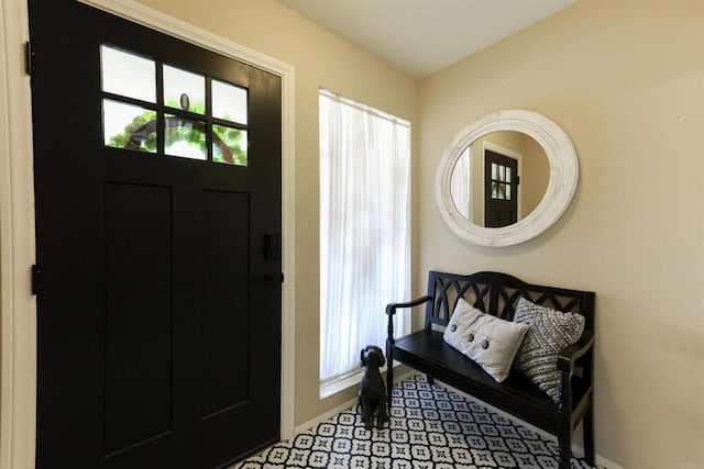 foyer entrance featuring baseboards