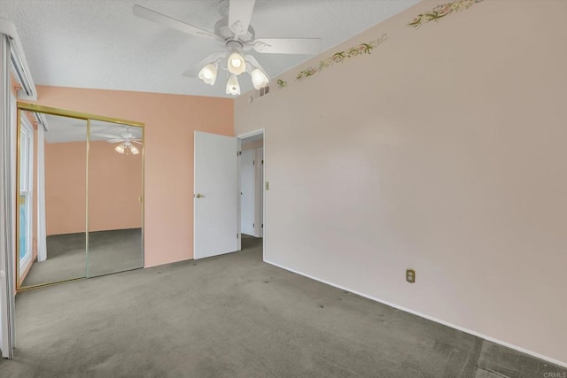 unfurnished bedroom featuring visible vents, ceiling fan, carpet, a closet, and a textured ceiling