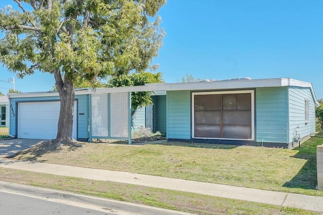 view of front of home featuring a garage and a front lawn