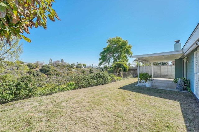 view of yard featuring a patio area and fence