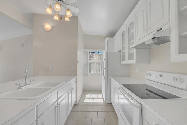 kitchen featuring under cabinet range hood, light countertops, white cabinets, white appliances, and a sink