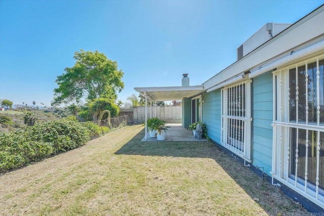 view of yard with a patio and fence