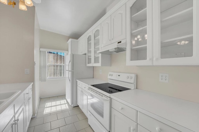 kitchen with under cabinet range hood, white appliances, white cabinets, light countertops, and glass insert cabinets