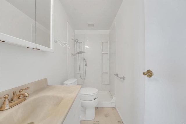 bathroom with visible vents, toilet, vanity, and walk in shower