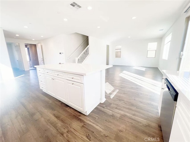 kitchen featuring open floor plan, dishwasher, light wood-style floors, and visible vents