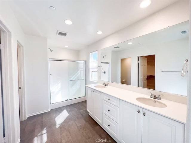 bathroom featuring a sink, visible vents, and a stall shower