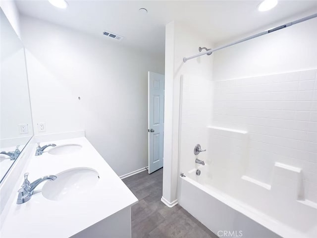 full bathroom with double vanity, visible vents, bathing tub / shower combination, and a sink