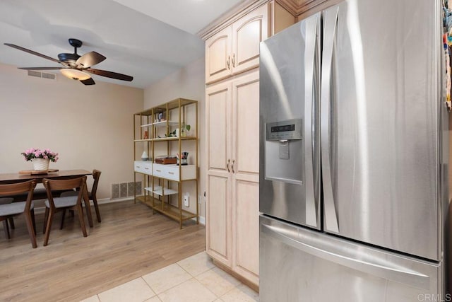 kitchen featuring light tile patterned flooring, visible vents, stainless steel refrigerator with ice dispenser, and ceiling fan