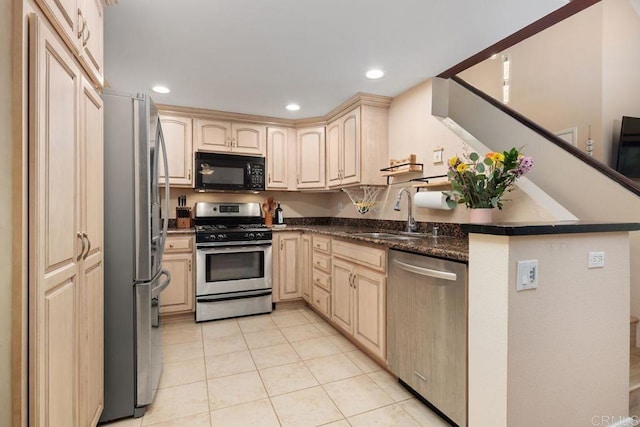 kitchen with recessed lighting, light brown cabinets, appliances with stainless steel finishes, and a sink