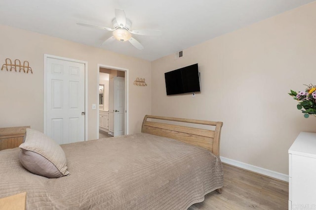 bedroom with a ceiling fan, visible vents, baseboards, light wood-style floors, and connected bathroom