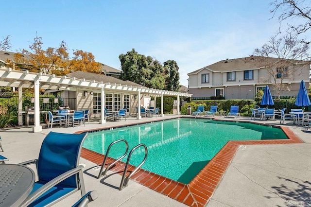 pool with fence, a patio area, and a pergola