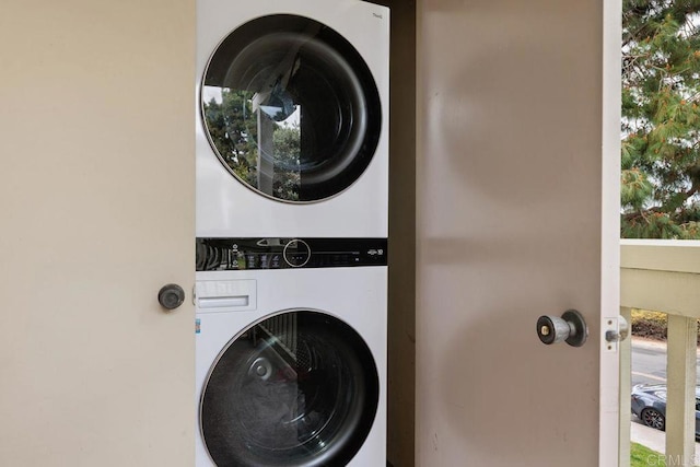 laundry room featuring stacked washer and dryer and laundry area