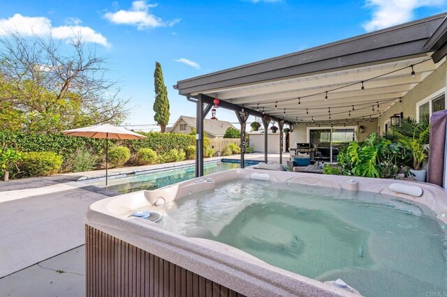 view of swimming pool featuring a patio, a fenced in pool, fence, and a hot tub