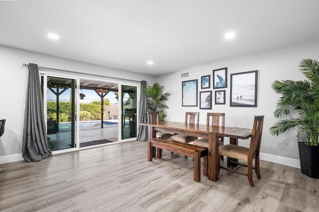 dining room featuring recessed lighting, baseboards, and light wood-style flooring