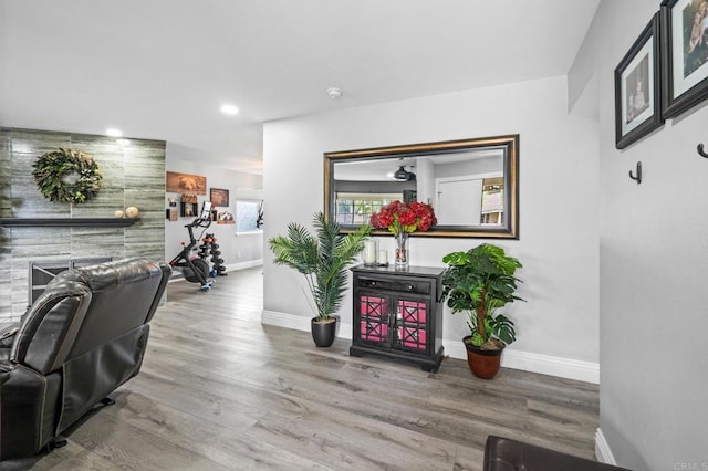 living room featuring recessed lighting, baseboards, and wood finished floors