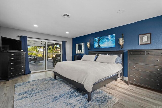 bedroom with recessed lighting, visible vents, wood finished floors, and access to outside